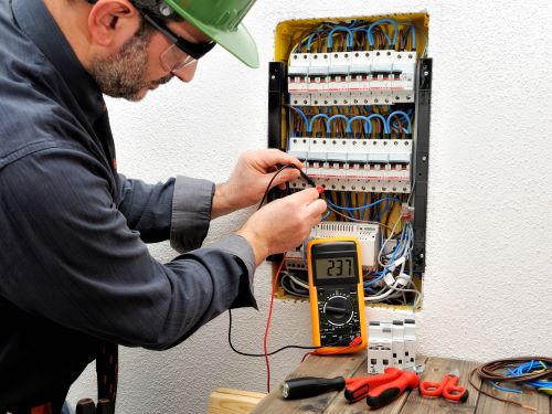 Électricien Champigny-sur-Marne - Un électricien effectue des vérifications sur un tableau électrique.