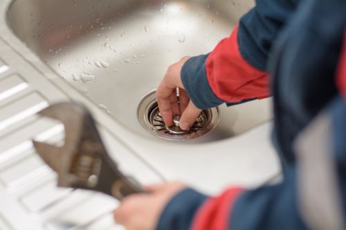 Plombier Anstaing - Un plombier teste l'évacuation d'eau d'un robinet.