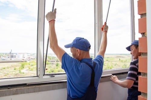 Vitrier Tourcoing - Deux artisans vitriers installent une baie vitrée.