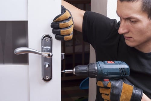 serrurier Clichy - un artisan installe une poignée de porte