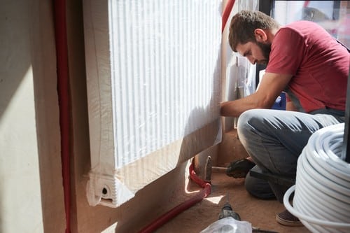 chauffagiste Bouc-Bel-Air - un artisan chauffagiste installe un radiateur