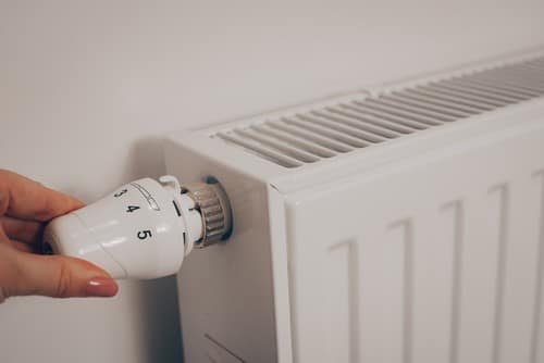 chauffagiste Villeneuve-lès-Avignon - Une personne change la température d'un radiateur.
