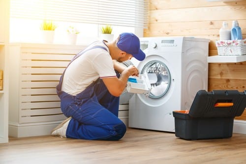plombier La Garde - un plombier répare une machine à laver