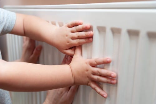 chauffagiste Le Kremlin-Bicêtre - Des mains d'enfant sur un radiateur chaud