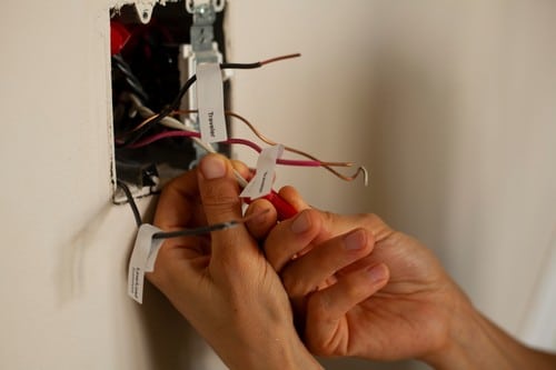 électricien Chevilly-Larue - Un électricien répare une prise électrique