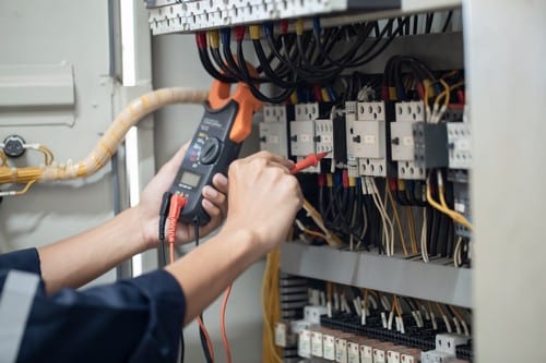 électricien Maurepas - Un électricien répare un tableau électrique