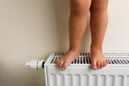 Chauffagiste Villers-Cotterêts - bébé debout sur un chauffage