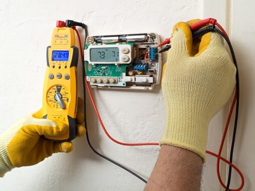 Climatisation Thiais - mains d'un homme qui règle un câble de climatiseur