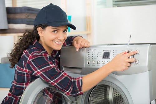 Plombier Enghien-les-Bains - femme qui règle une machine à laver