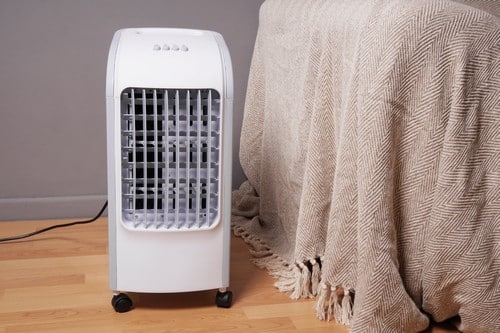 Climatisation La Mulatiere - visuel d'un climatiseur posé à côté d'un lit