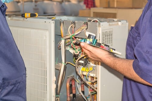 Climatisation Apt - personnes qui règlent un climatiseur